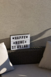At home on the balcony, sign 'happy home staying' At home on the balcony, sign 'happy home staying'